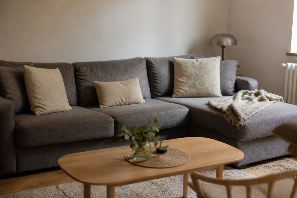 Canape d angle gris avec coussins beiges dans salon